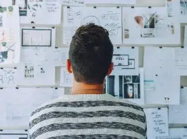 office worker looking at full white board