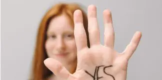 woman holding up hand saying yes
