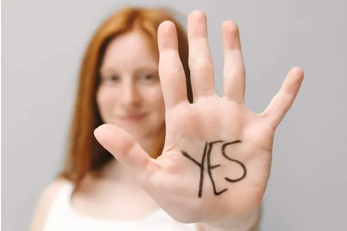 HRHQ Saying yes starts with a no woman holding up hand saying yes