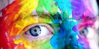 close up of eye on brightly painted face