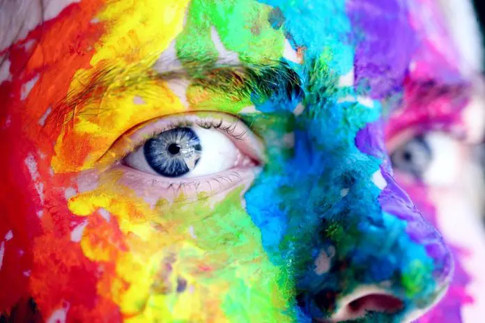 close up of eye on brightly painted face