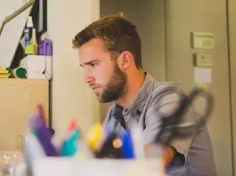 man concentrating on work at laptop