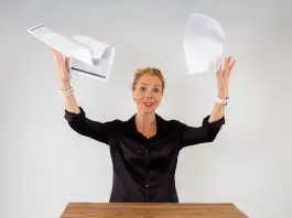 stressed woman throwing papers in the air
