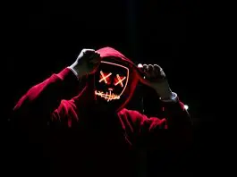 red hoodie person on black silhouette with digital face
