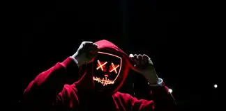 red hoodie person on black silhouette with digital face