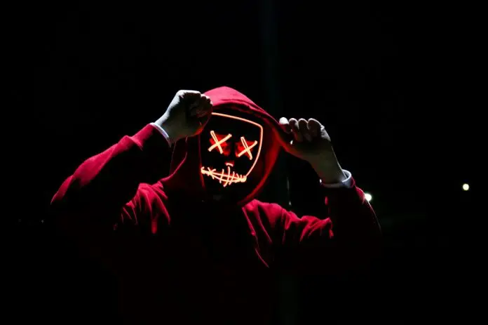 pexels-sebastiaan-stam-1097456 red hoodie person on black silhouette with digital face