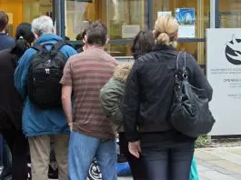people lining up outside social welfare office