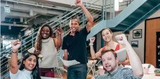 group of pumped up and motivated people in office