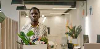 man leaving office with belongings in a box