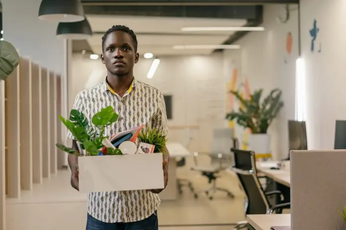 man leaving office with belongings in a box