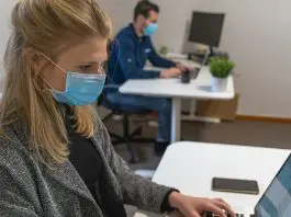 Woman in office wearing Covid mask