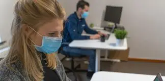 Woman in office wearing Covid mask