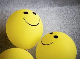 smiling faces on yellow balloons