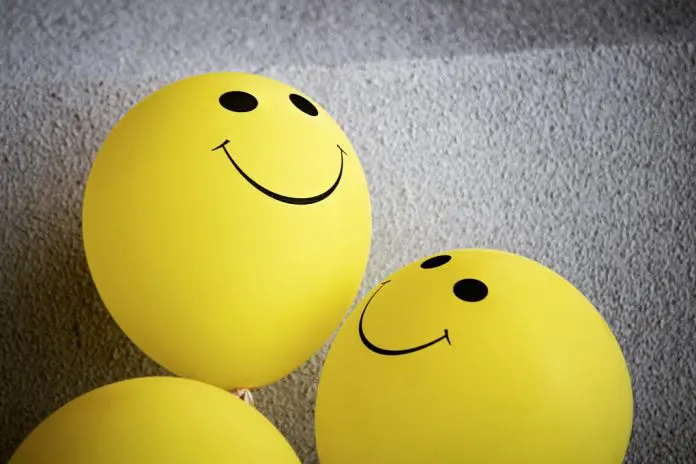 pexels-tim-mossholder-3612885 smiling faces on yellow balloons