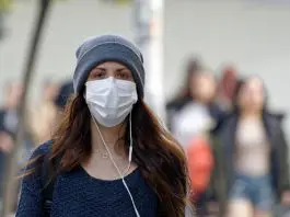 Woman wearing face mask on way to work