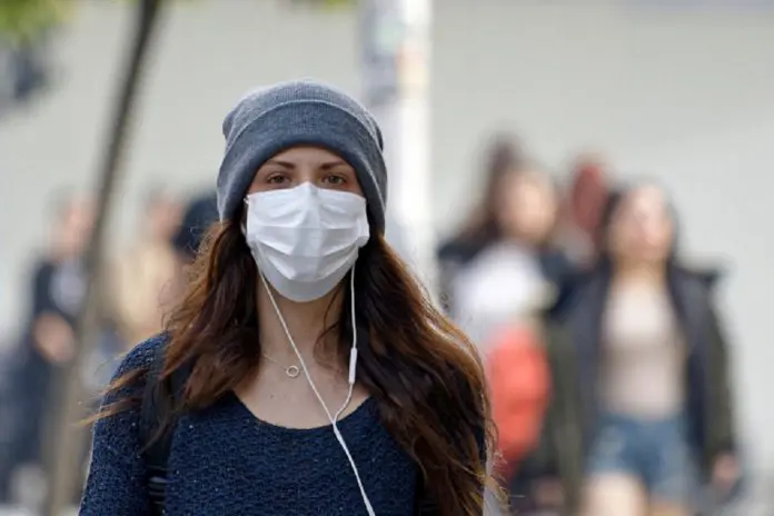 HRHQ Pandemic woman on way to work Woman wearing face mask on way to work