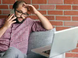 stressed worker sitting beside laptop