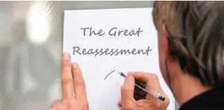 man writing note against door