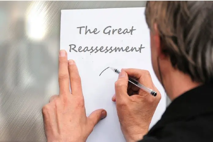HRHQ The Great Reassessment’ man writing note against door