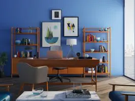 beautiful home office with blue wall and pictures