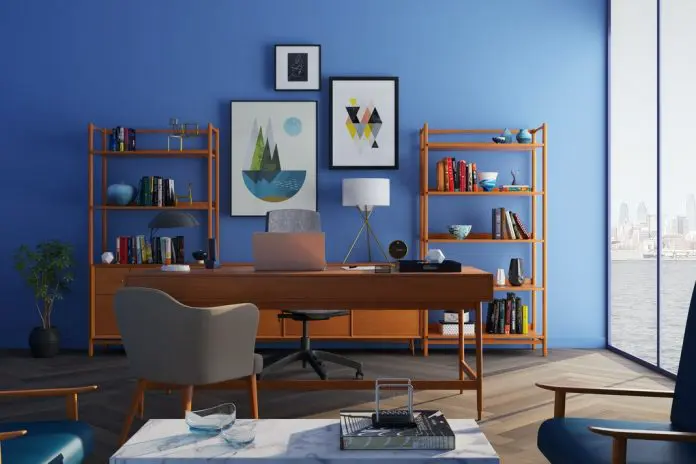 beautiful home office with blue wall and pictures