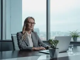 woman in grey blazer sitting table