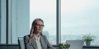 woman in grey blazer sitting table