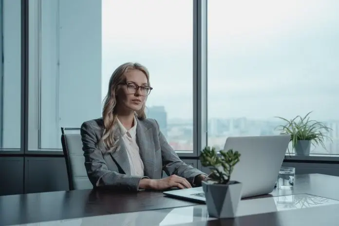 pexels-tima-miroshnichenko-5717512 woman in grey blazer sitting table