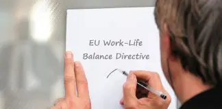 man writing notice on sheet of paper