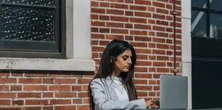 woman working remotely at laptop in city