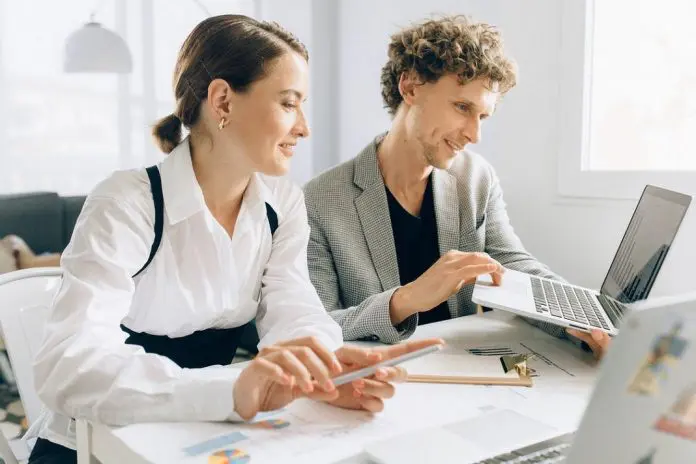 Intern with employee in office