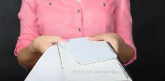 woman handing over notebooks