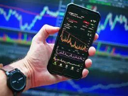 person holding phone displaying information graph