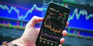 person holding phone displaying information graph