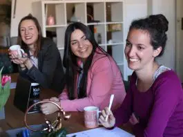 small group of women in office laughing