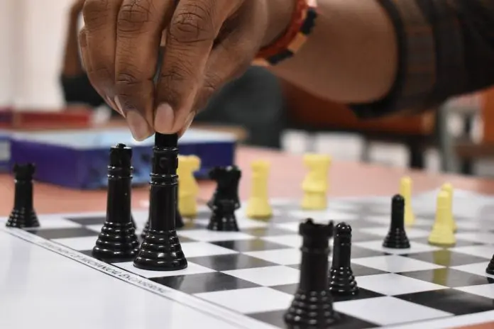 pexels-koushik-bala-3830671 person making a chess move