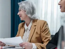 lady with agenda in hand running meeting