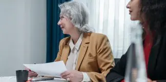 lady with agenda in hand running meeting