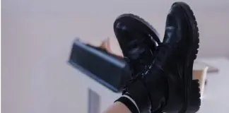 employee with feet on desk