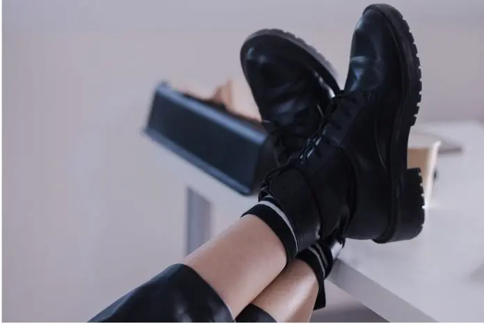 employee with feet on desk