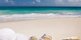 hat and shoes on sunny beach