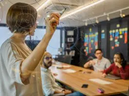 lady leading team through plan on clear whiteboard