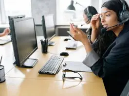 employee sitting at computer screen