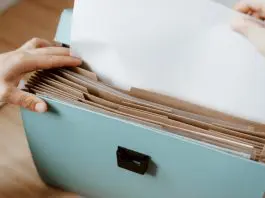 hand placing document in file