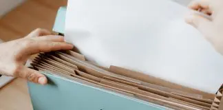 hand placing document in file