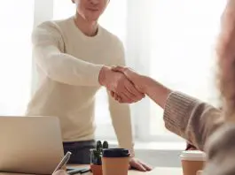 man and woman shaking hands after interview