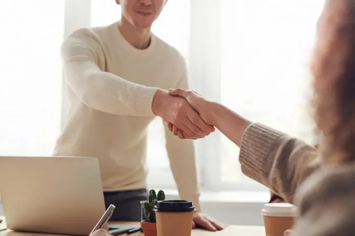 pexels-fauxels-3184465 man and woman shaking hands after interview