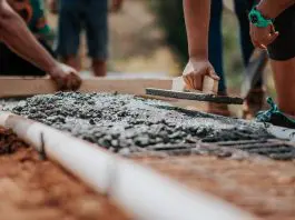 builder laying cement foundation