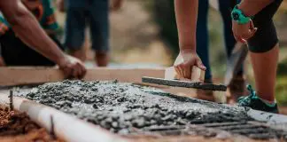 builder laying cement foundation