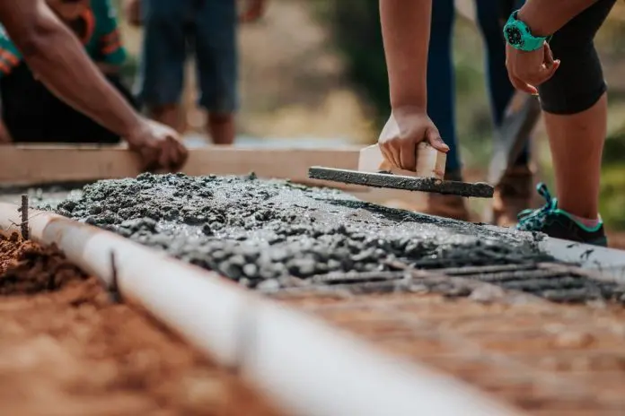 builder laying cement foundation